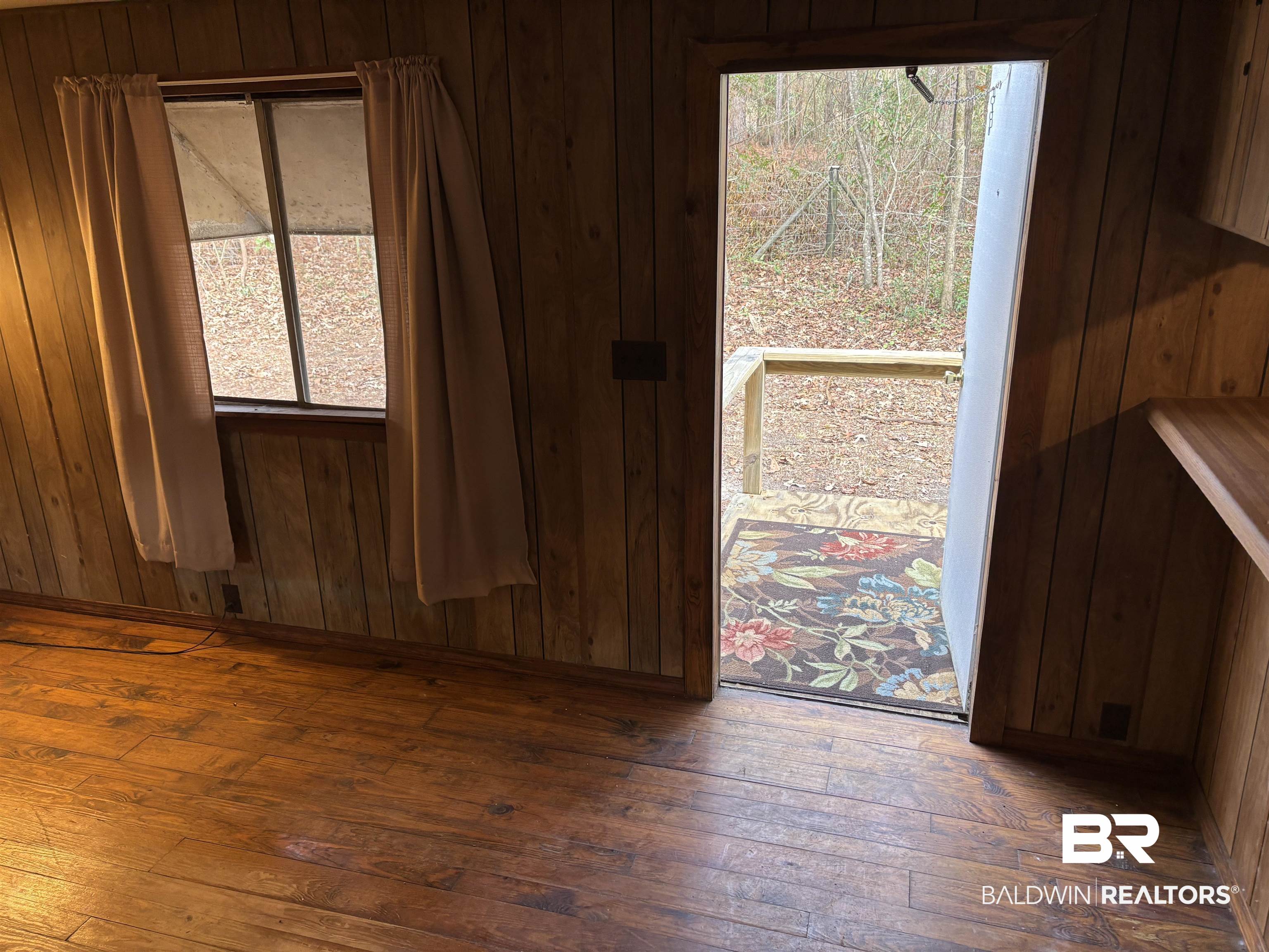 15575 Rogers Drive Chunchula, AL 36521 - Photo 32 of 42 Unfurnished room featuring wood walls and dark wood-type flooring