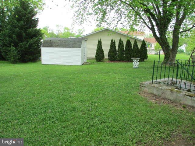 7301 Gunpowder Road Baltimore, MD 21220 - Photo 22 of 29 a view of a white house with a yard and tree s