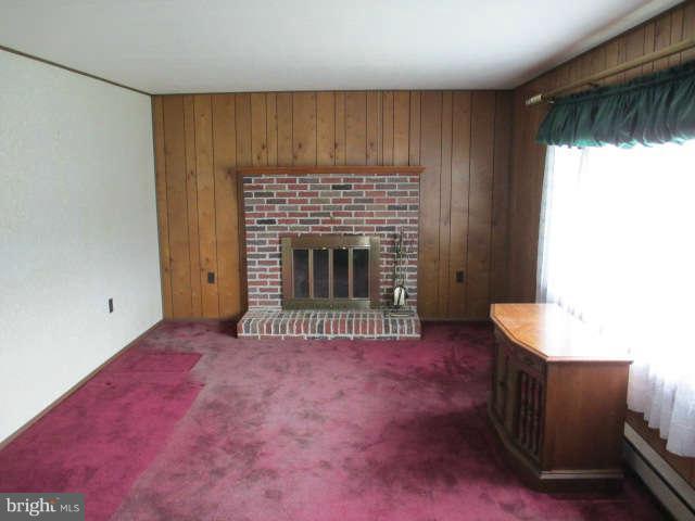 7301 Gunpowder Road Baltimore, MD 21220 - Photo 6 of 29 an empty room with windows and fireplace