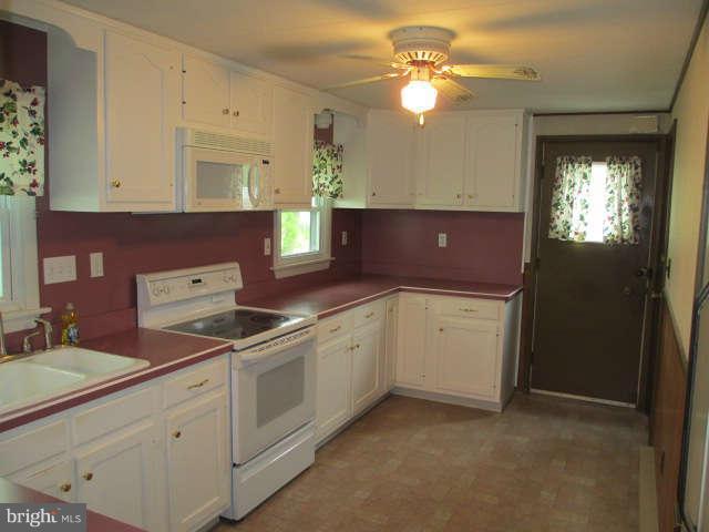 7301 Gunpowder Road Baltimore, MD 21220 - Photo 7 of 29 a kitchen with a stove a sink and a window