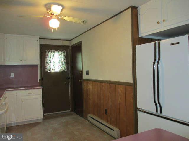 7301 Gunpowder Road Baltimore, MD 21220 - Photo 8 of 29 a view of a kitchen with a refrigerator and a ceiling fan