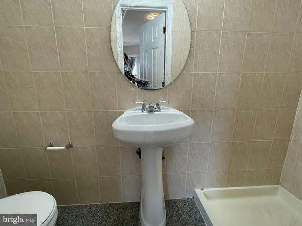 a bathroom with a sink a toilet and mirror
