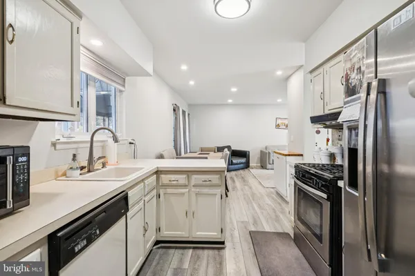 a kitchen with a sink stove and refrigerator