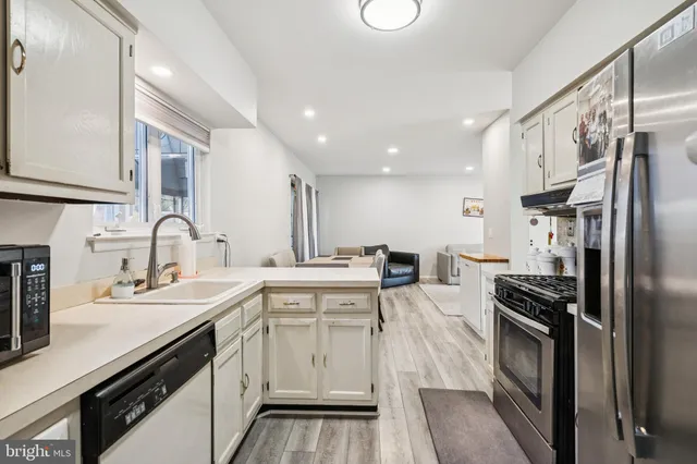 a kitchen with a sink stove and refrigerator