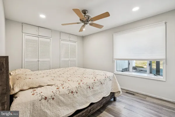 a bedroom with a large bed and a large window