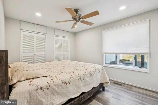 a bedroom with a large bed and a large window