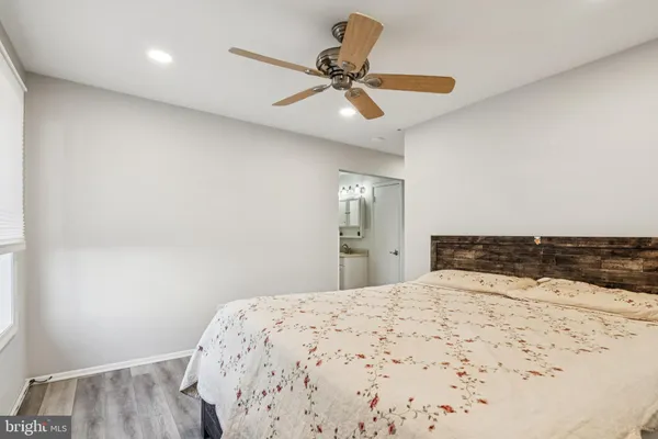 a room with a bed and a dresser