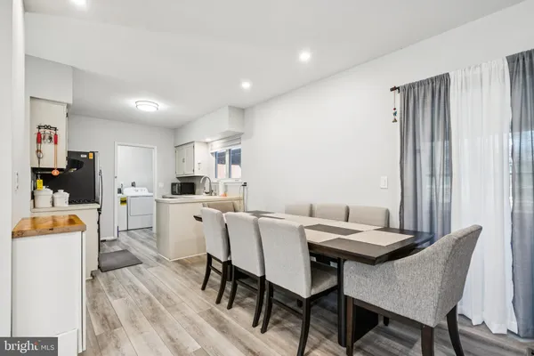 a view of a dining room with furniture and a window