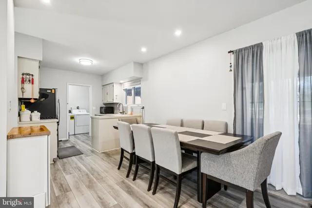 a view of a dining room with furniture and a window