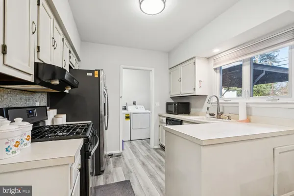 a kitchen with a stove a sink and a refrigerator