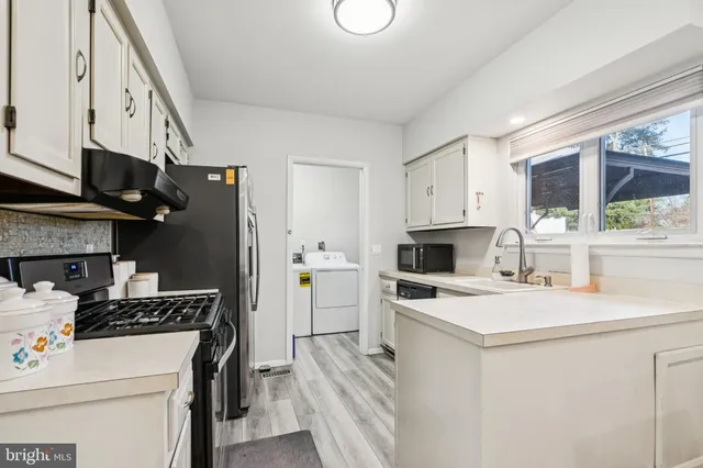 a kitchen with a stove a sink and a refrigerator