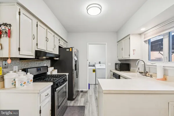 a kitchen with a sink a stove and refrigerator