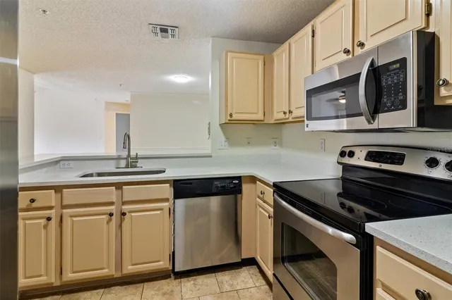 a kitchen with cabinets appliances and a sink