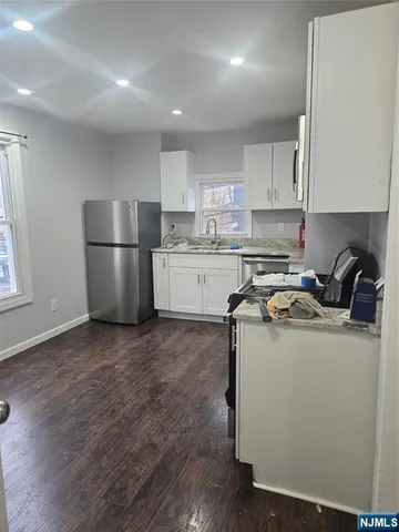 a kitchen with a sink a stove a refrigerator and cabinets