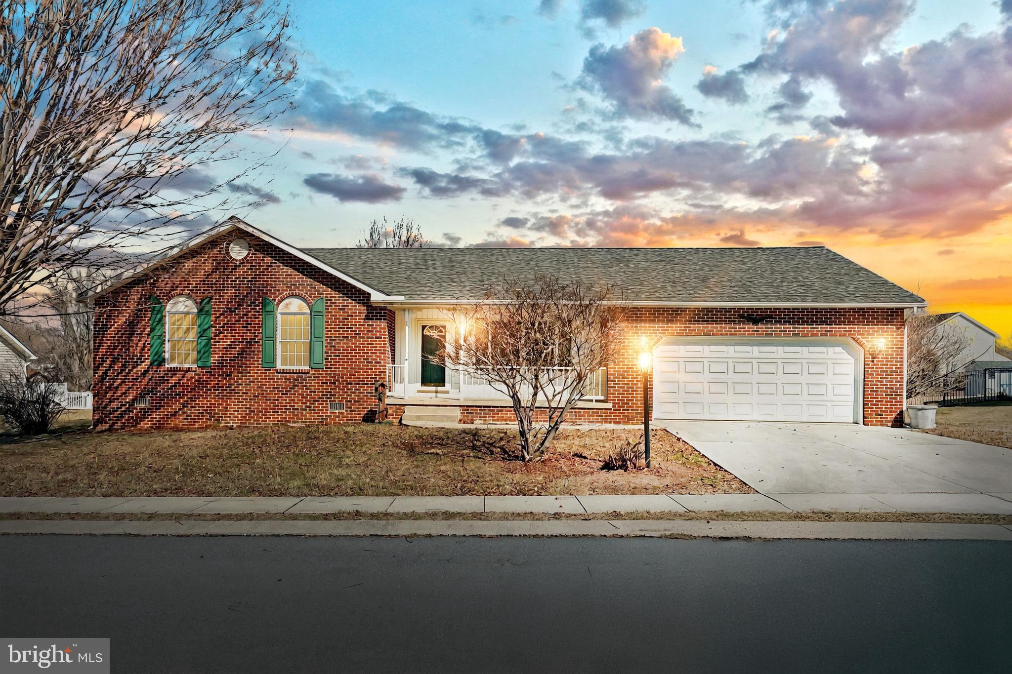 a view of a house with car parked