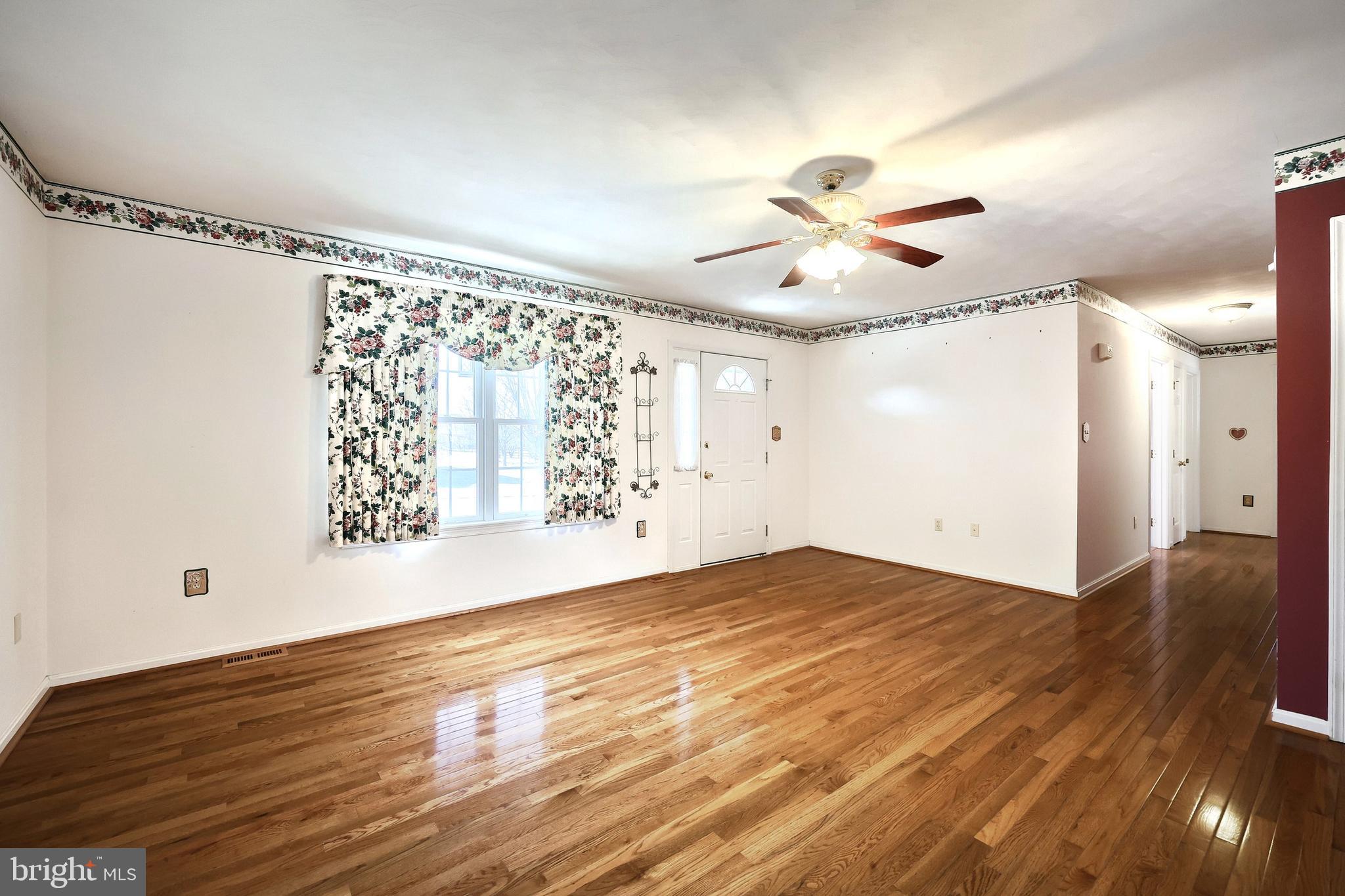 105 Wheaton Drive Littlestown, PA 17340 - Photo 3 of 39 wooden floor in an empty room with a window