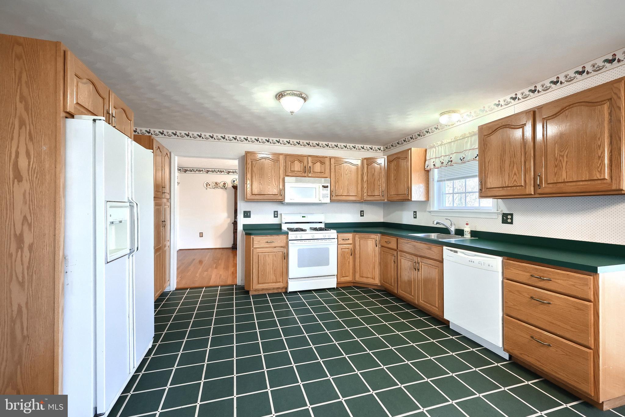 105 Wheaton Drive Littlestown, PA 17340 - Photo 7 of 39 a kitchen with stainless steel appliances granite countertop a refrigerator and a stove top oven