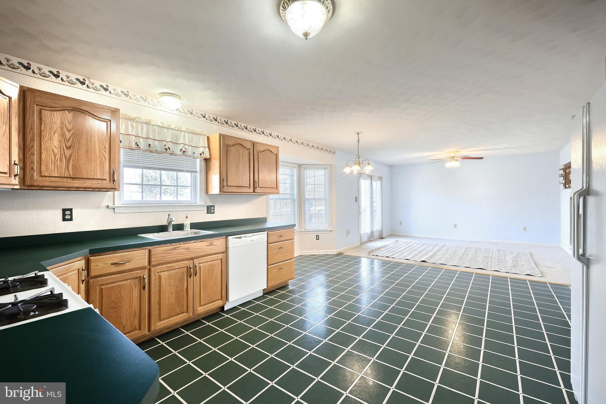 105 Wheaton Drive Littlestown, PA 17340 - Photo 8 of 39 a large kitchen with kitchen island granite countertop a sink and a stove