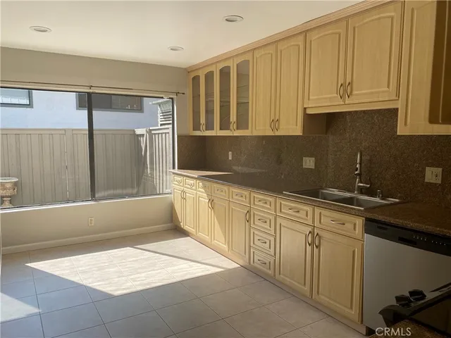 a kitchen with stainless steel appliances granite countertop a refrigerator and cabinets
