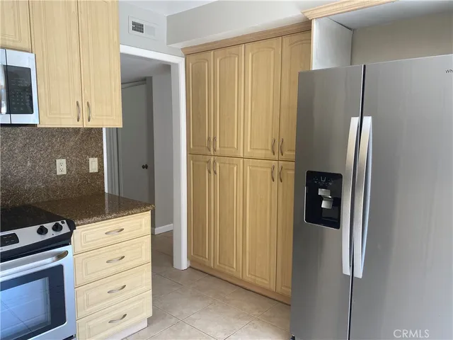 a kitchen with appliances and cabinets
