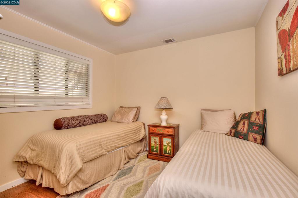 Undisclosed Address Walnut Creek, CA 94596 - Photo 12 of 12 a bedroom with a bed and window
