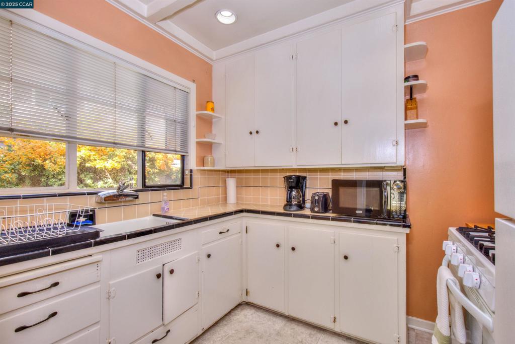 Undisclosed Address Walnut Creek, CA 94596 - Photo 7 of 12 a kitchen with white cabinets and a sink