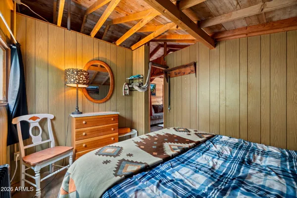 a bedroom with a bed and a painting on the wall