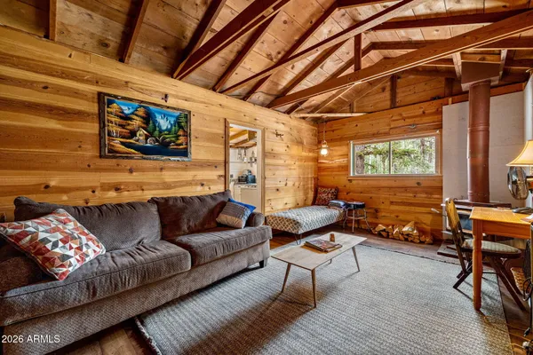 a living room with furniture a couch and a flat screen tv