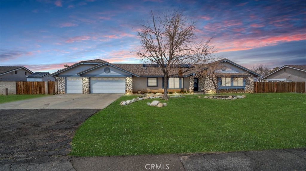 13302 Cochise Road Apple Valley, CA 92308 - Photo 1 of 1 a front view of a house with a garden