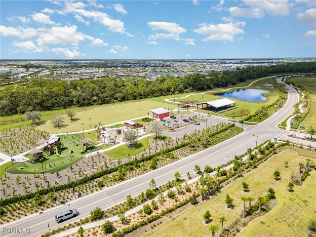 a view of a city with lots of residential buildings ocean and mountain view in back