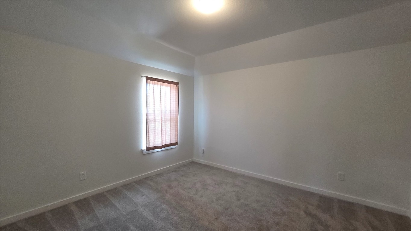 1015 Thor Roman Forest, TX 77357 - Photo 13 of 15 an empty room with windows and closet