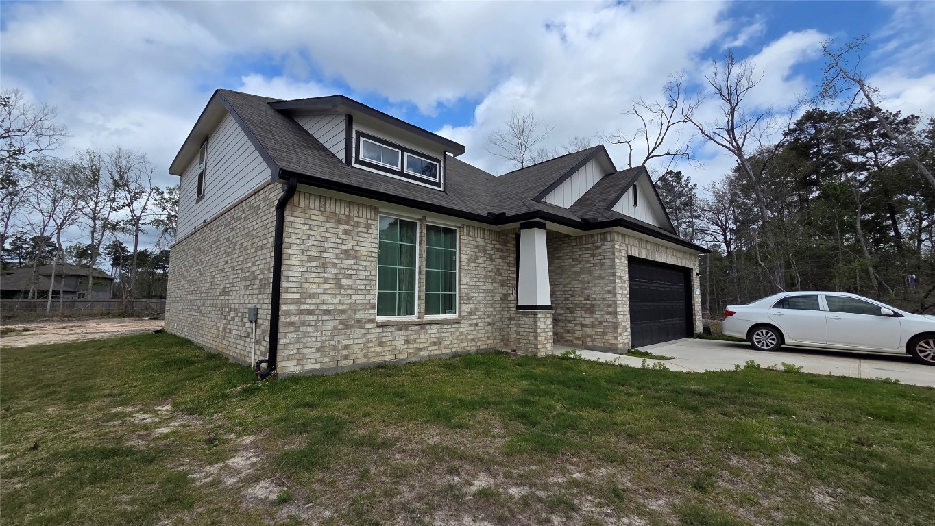 1015 Thor Roman Forest, TX 77357 - Photo 2 of 15 a view of a house with a yard
