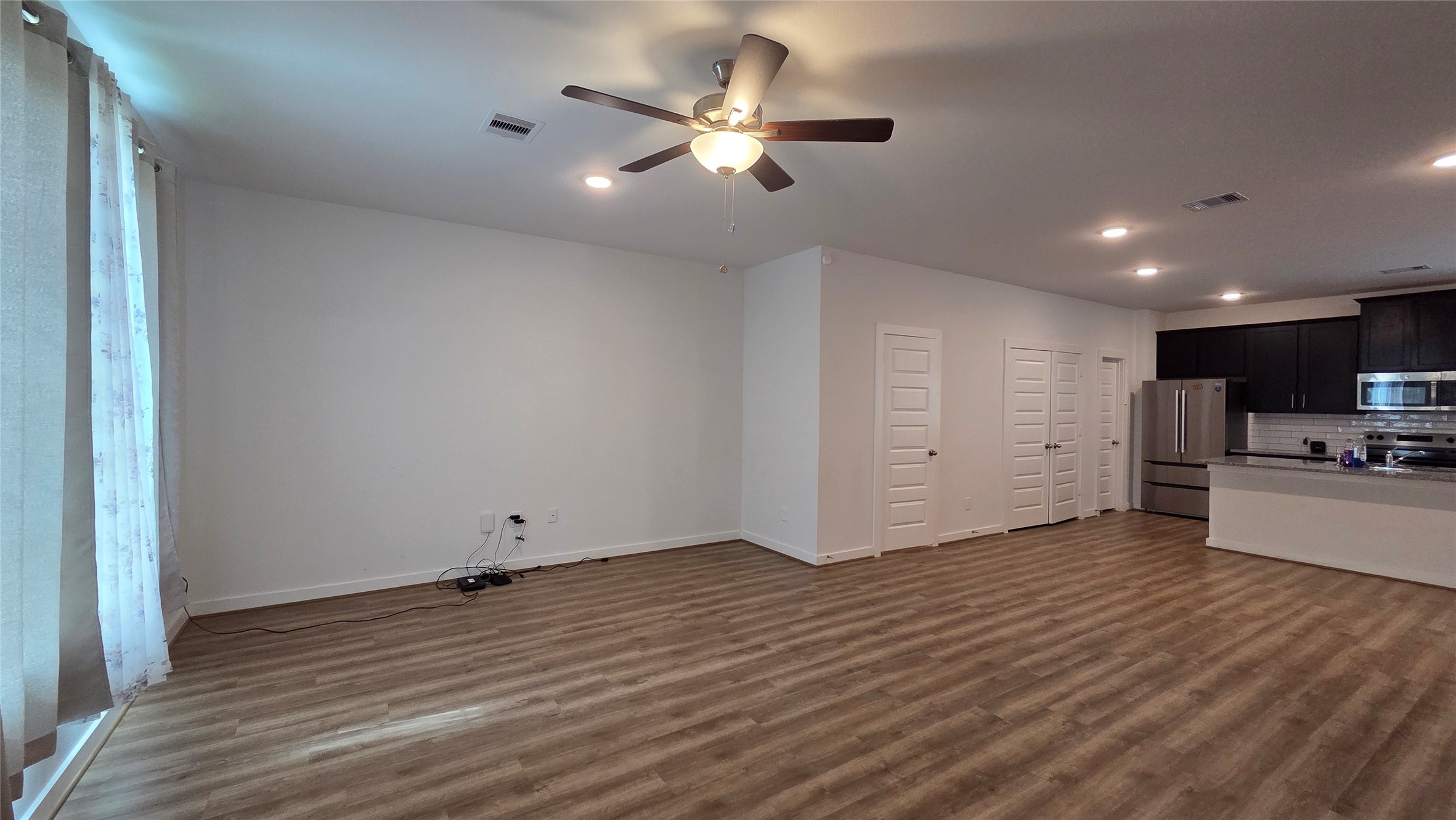 1015 Thor Roman Forest, TX 77357 - Photo 3 of 15 a view of a livingroom with furniture a ceiling fan and wooden floor