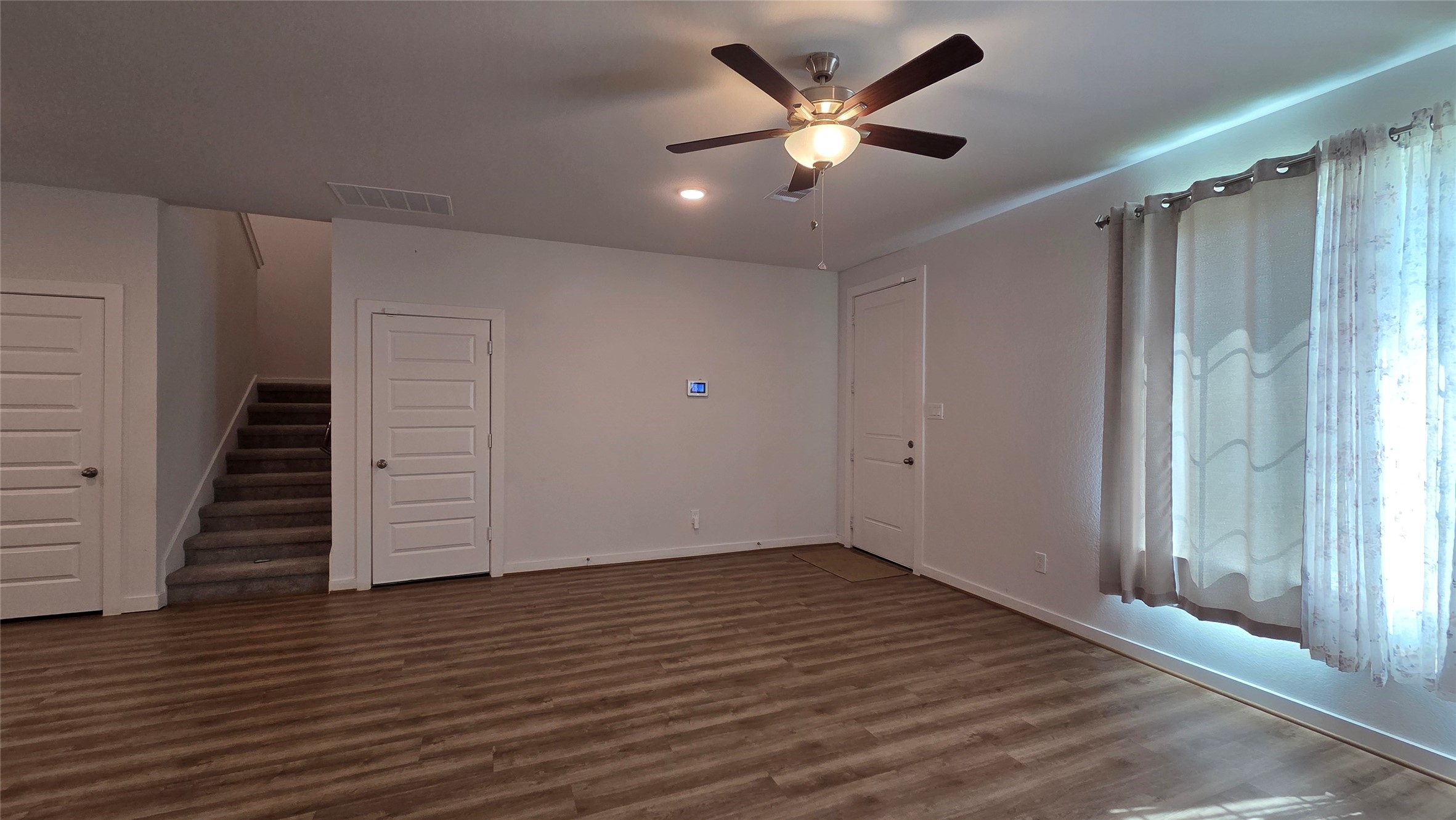 1015 Thor Roman Forest, TX 77357 - Photo 5 of 15 an empty room with wooden floor and windows