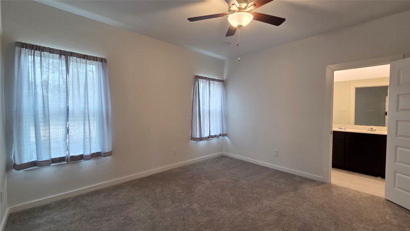 1015 Thor Roman Forest, TX 77357 - Photo 7 of 15 an empty room with windows and fan