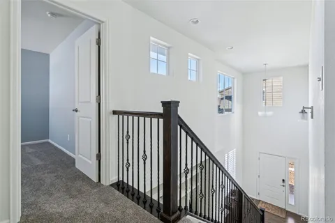 a bedroom with a large bed a flat tv screen and a dresser