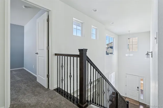 a bedroom with a large bed a flat tv screen and a dresser