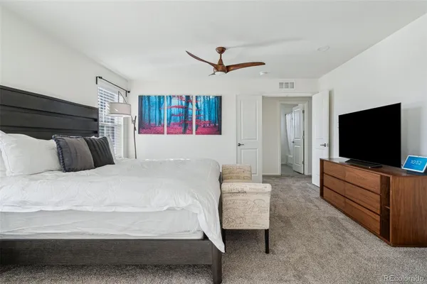a bed room with a bed and a television