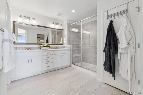 a bathroom with a double vanity sink and a mirror
