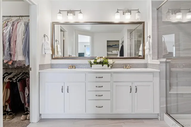 a bathroom with a shower and a sink a mirror