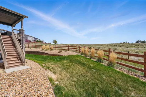 a view of a garden with lawn chairs