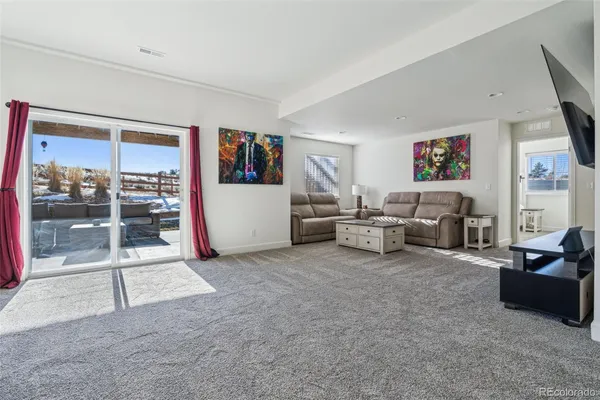 a view of a livingroom with furniture and a flat screen tv
