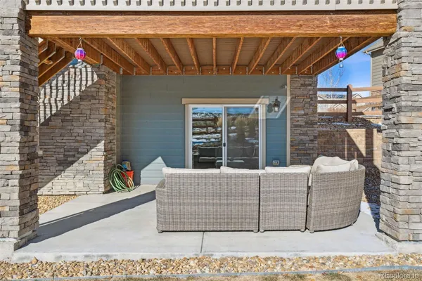 a roof deck with couch and outdoor view