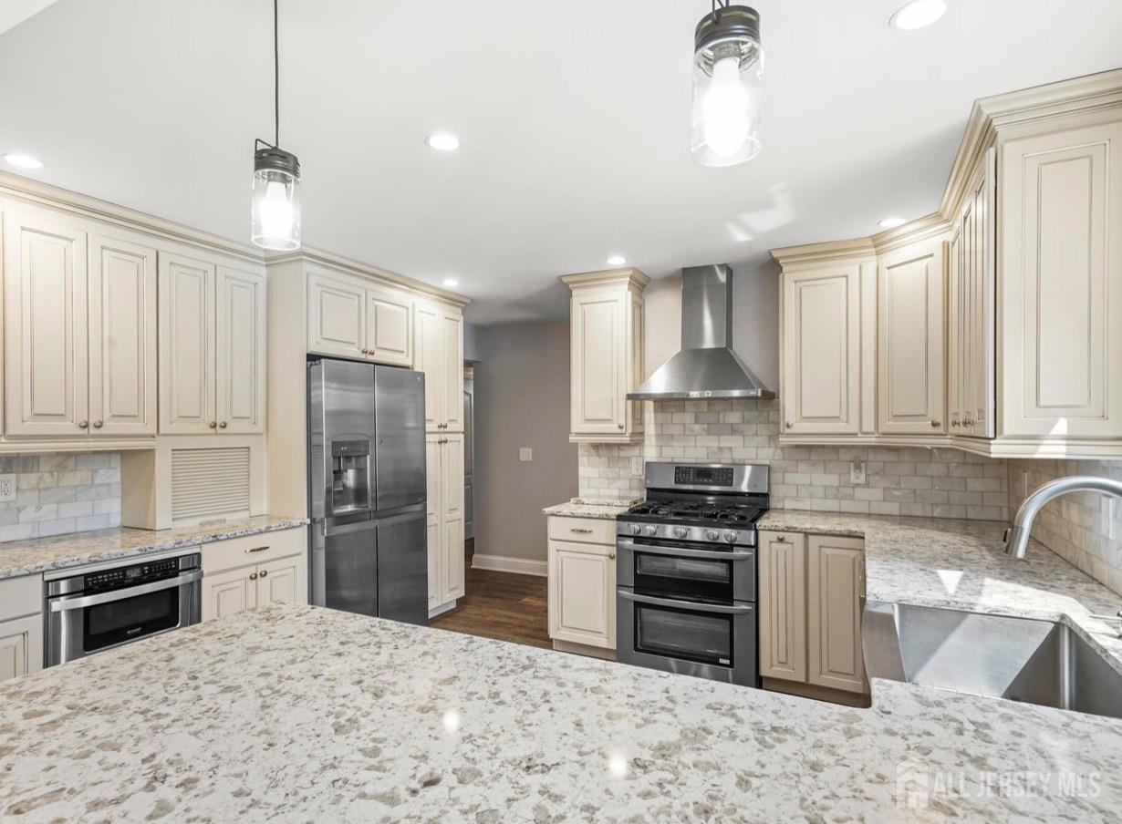 13 Crabtree Road Old Bridge, NJ 07747 - Photo 11 of 32 a kitchen with granite countertop a stove sink and refrigerator