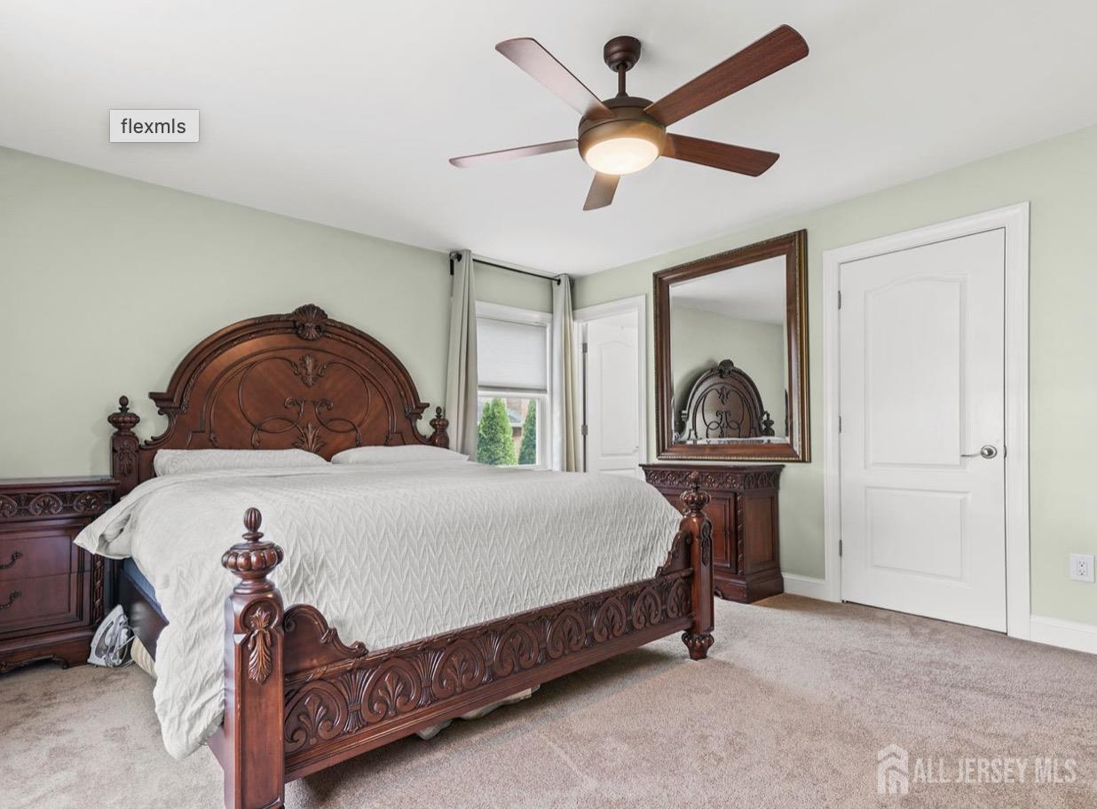 13 Crabtree Road Old Bridge, NJ 07747 - Photo 18 of 32 a bedroom with a bed a window and a chandelier