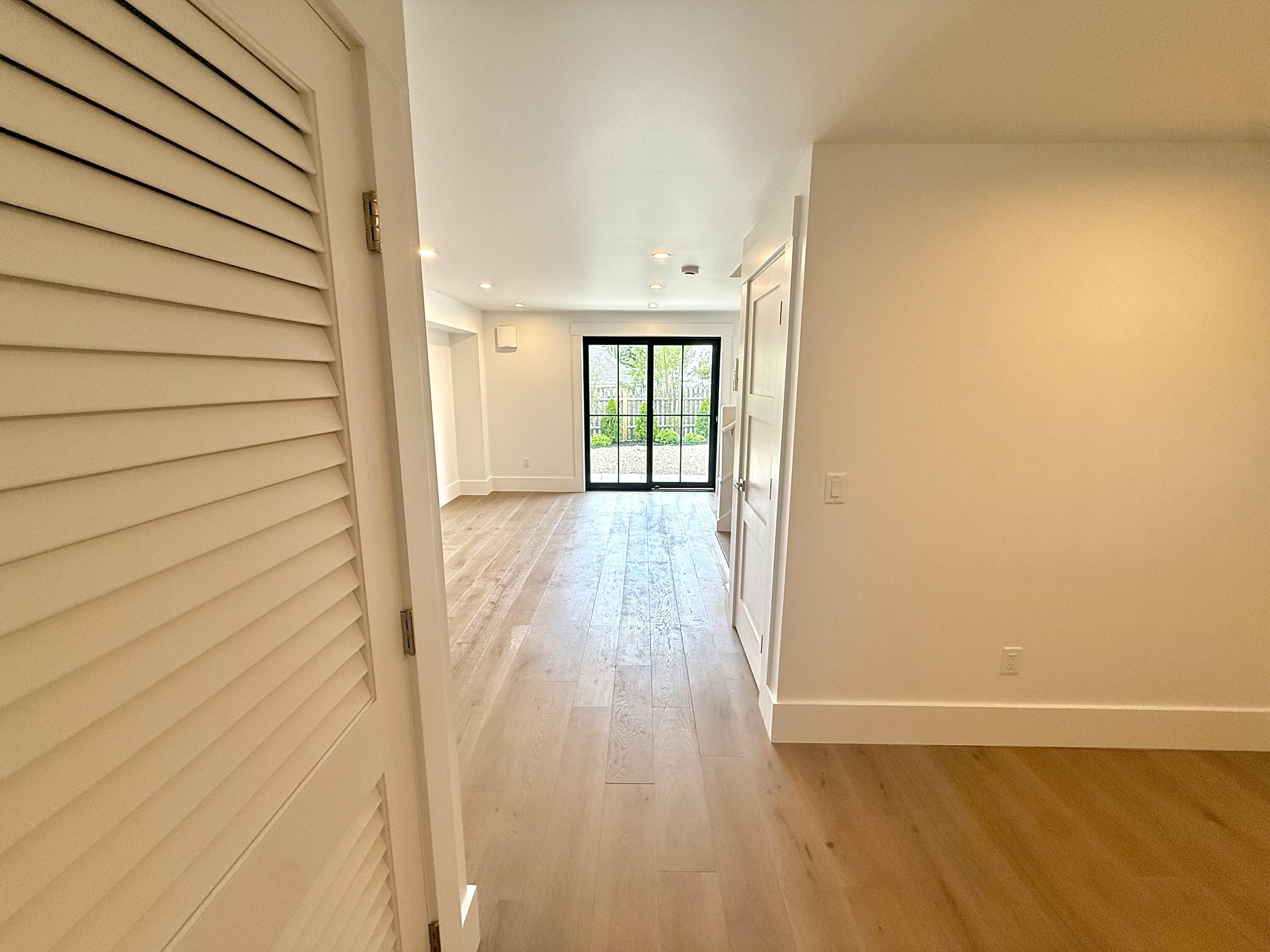 29 Cemetery Road, Unit 2 Provincetown, MA 02657 - Photo 12 of 30 a view of an empty room with wooden floor and a window