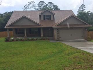 3636 Ranch Drive Crestview, FL 32539 - Photo 1 of 26 a front view of a house with garden