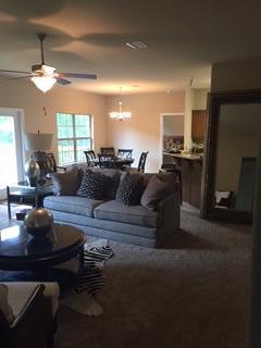 3636 Ranch Drive Crestview, FL 32539 - Photo 12 of 26 a living room with furniture a chandelier and a fireplace