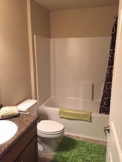 3636 Ranch Drive Crestview, FL 32539 - Photo 22 of 26 a bathroom with a granite countertop sink toilet and shower