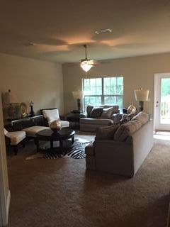 3636 Ranch Drive Crestview, FL 32539 - Photo 4 of 26 a living room with furniture and a chandelier
